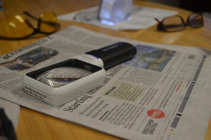 Services AVL picture of magnifying glass on top of newspaper. Skills Training