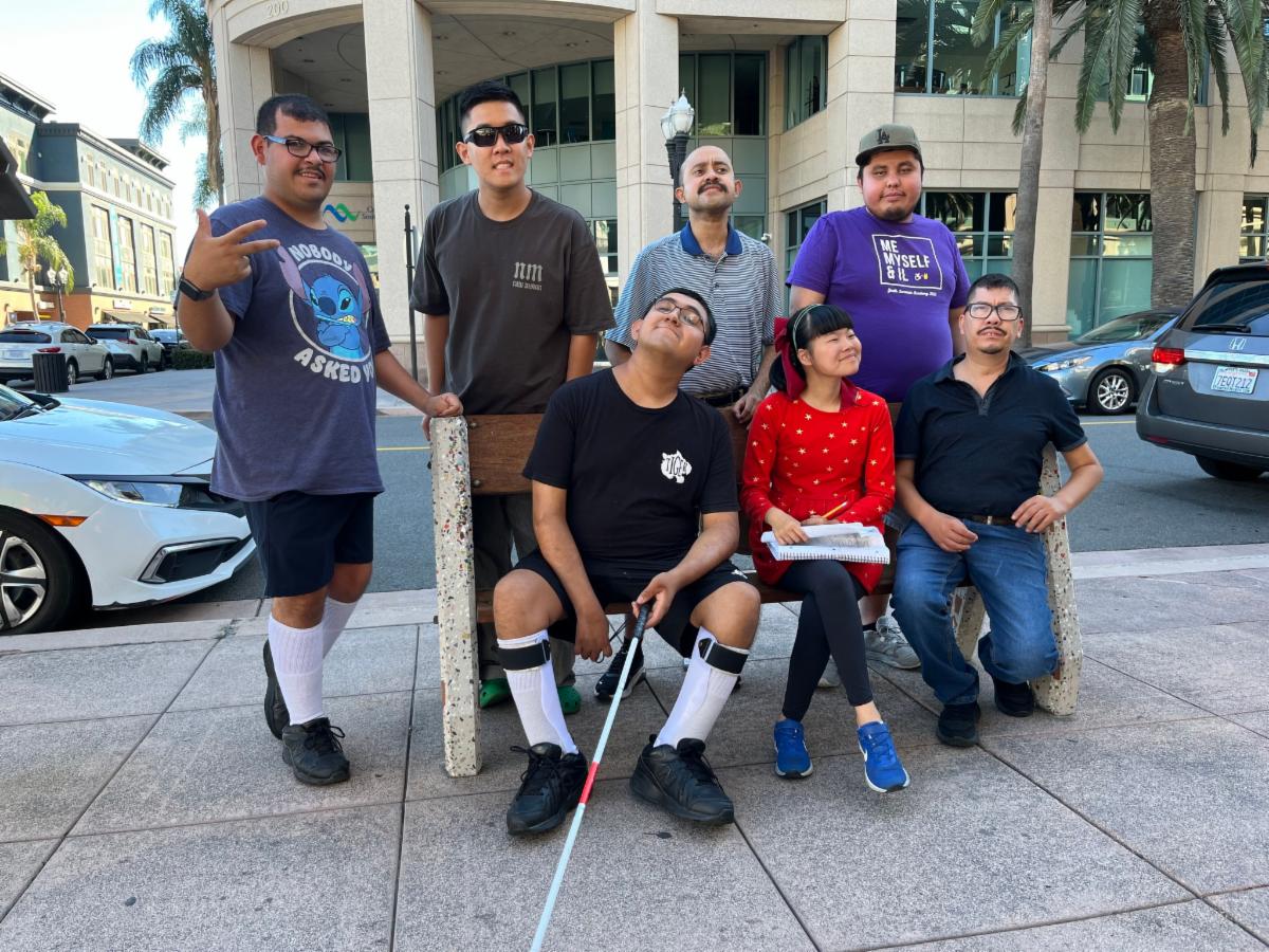 DMC Youth Connect participants outside smiling in group photo during program outing.