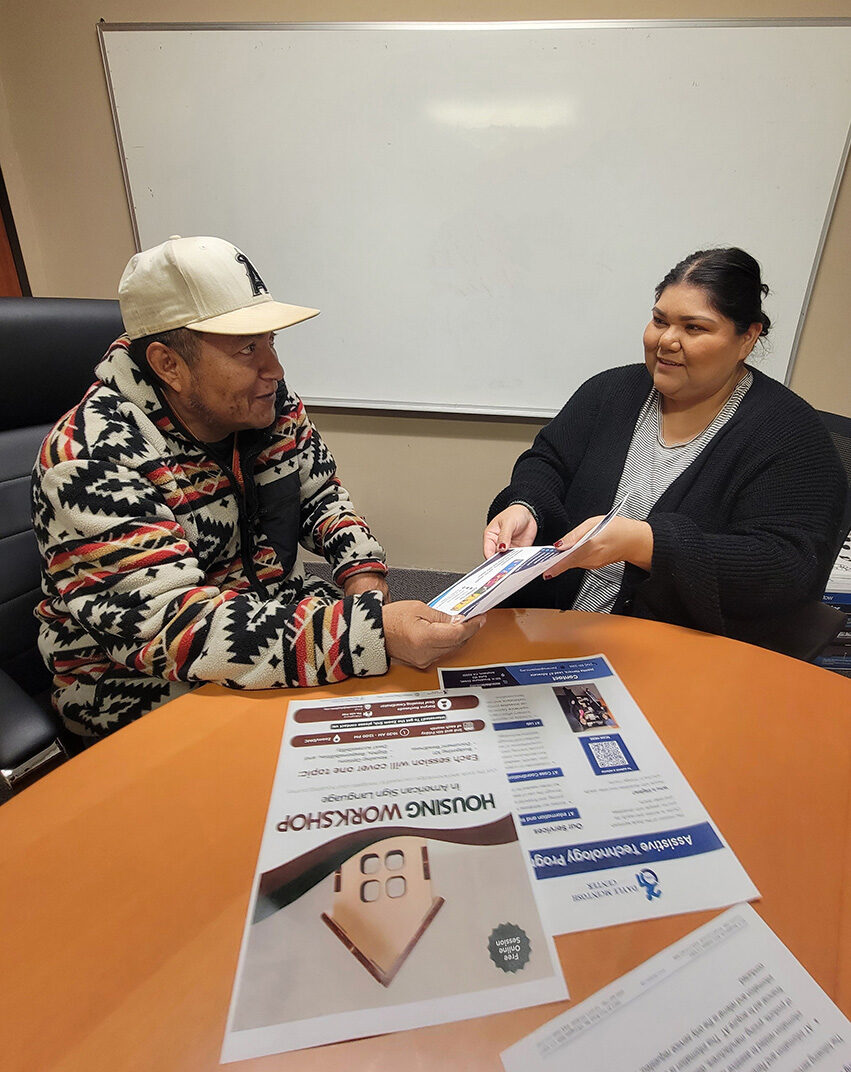 L-R  DMC Consumer with Esmeralda Sandoval, ILS Community Living Advocate going over available information resources.
