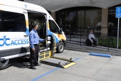 OCTA-Photo-Shoot-6-DMC-Past-Board-VP-using-ramp-to-meet-OC-ACCESS-Attendant-is-standing-by-with-wheelchair-lift-ready-to-receive-rider