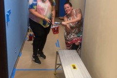 Photo-1-Hallway-being-painted-with-blue-paint-in-progress-Brittany-and-Megan-painting