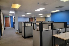 Photo-2-DMC-offices-with-walls-painted-in-blue-features-several-cubicles-in-a-row-with-an-area-with-Blue-Paint-to-the-right