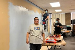 Photo-7-Painting-at-DMC-Teamwork-makes-the-dream-work.-Team-members-collaborating-smiling-before-work-begins