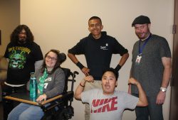 Services Picture of instructor and 4 youth consumers. One youth is flexing his muscles.
