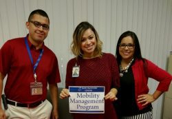 Community Services 3 staff doing an outreach standing at MMP resource table.