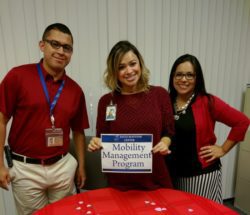 Community Services 3 staff standing at MMP resource table.