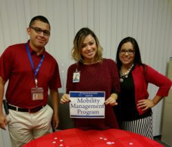 Community Services 3 staff standing at MMP resource table.