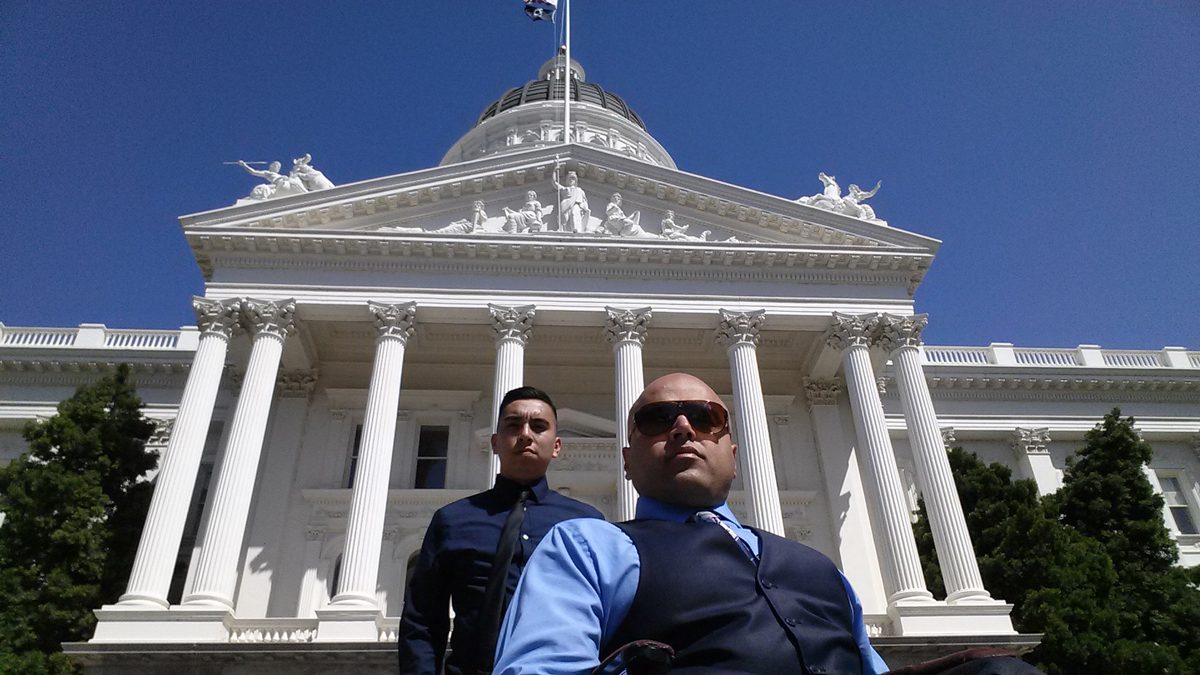 Systems Advocacy two male staff posing infront of California State Capitol in Sacramento