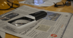 Services AVL picture of magnifying glass on top of newspaper.