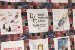 Picture of Quilt with square that says, DMC, Dayle McIntosh Center, Brenda Premo, Founding Mother, 1977