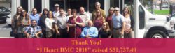 Thank You DMC 2018 Banner Staff in front of bus