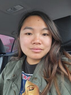 Woman with long brown hair in a car.