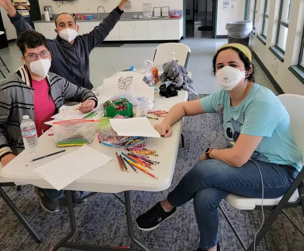 A group of youth at the arts and craft station.