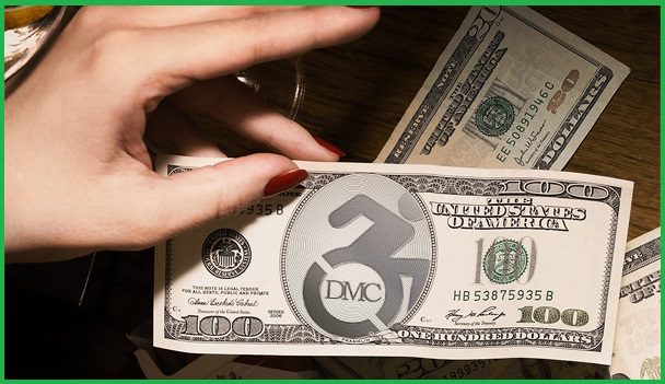 PIctured, paper money with DMC's logo in the center.