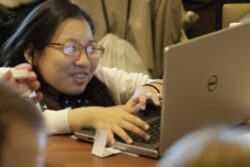 Picture of person on lap top excited to learn.