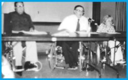 City Council conference table. Far Left, Mick Spencer, Right, Dayle McIntosh speaking
