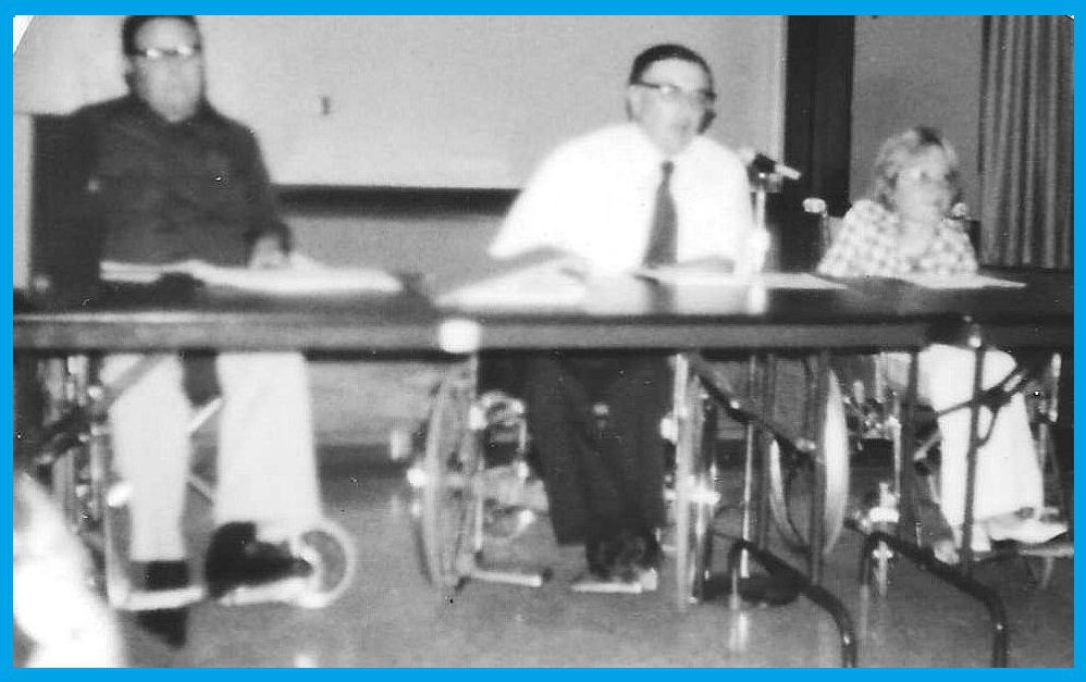 City Council conference table. Far Left, Mick Spencer, Right, Dayle McIntosh speaking