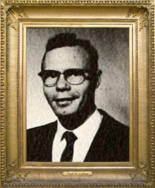 Dr. Paul M. Culton is smiling softly, wearing glasses, business suit, shirt and tie. The photo is from his high school yearbook. 