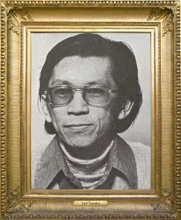 Tad Tanaka is a Japanese-American, wearing glasses, has dark hair and is wearing turtle neck underneath a collared shirt. The photo was provided by both Cypress College’s Deaf Services Roosevelt Center, from when he was a counselor, a same photo provided by his living family. 