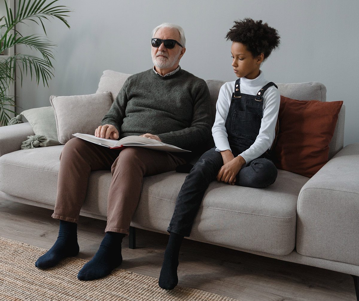 Older person using Braille to read a story 