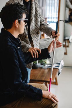Pictured, person learning how to use a cane.