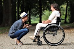 Two people in smiling discussion, supporting one another through face-to-face conversation