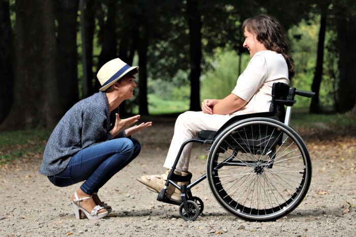 Two people in smiling discussion, supporting one another through face-to-face conversation