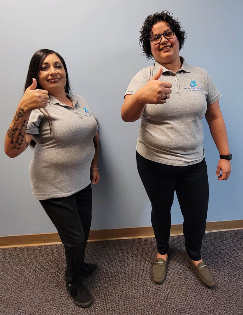 Pictured two DMC staff members giving a thumbs up to success stories