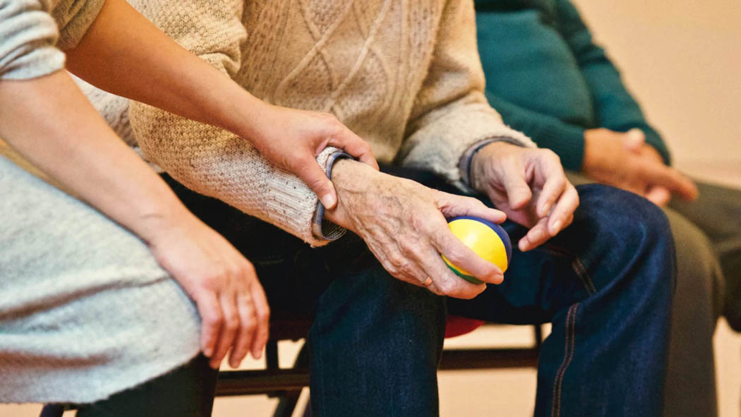 Peer support being shown to an older adult with a comforting hand