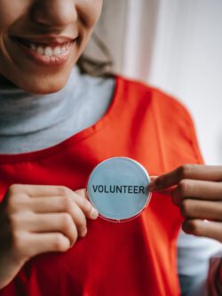 Pictured, DMC Volunteer showing up for service with a smile.
