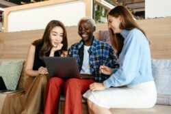 Pictured three people ready to sign up on DMC’s website to volunteer.