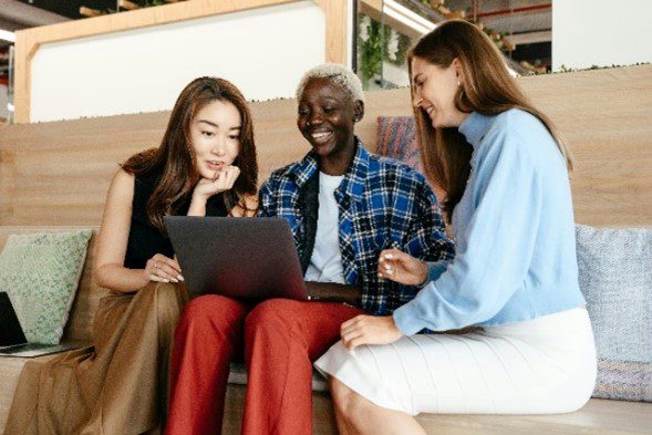 Pictured three people ready to sign up on DMC’s website to volunteer.