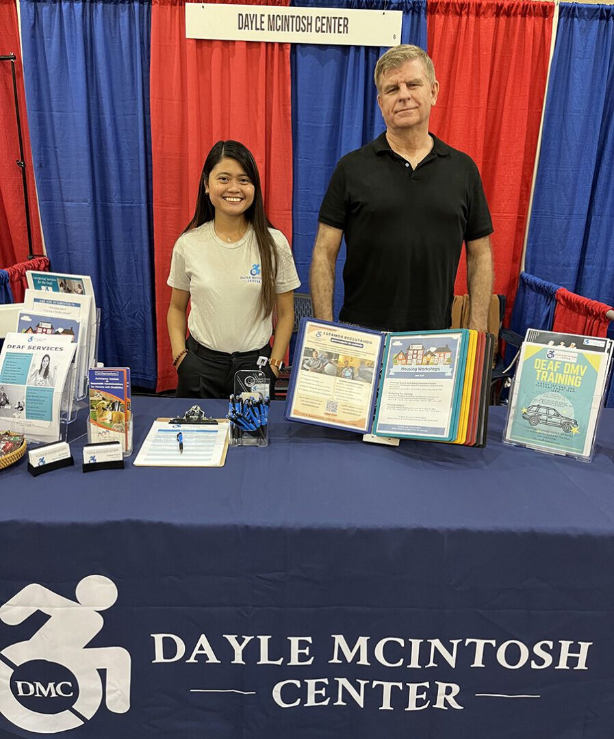 Pictured, DMC Deaf Housing Coordinator Doryna and Jet Hurly, Deaf Services Advocate at Deaf Nation Conference representing DMC at booth.