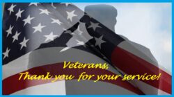 Pictured, Silhouette of a soldier and U.S. flag overlapping with blue sky and white clouds in background. Written in yellow text “Veterans Thank you for your service” is written on image.