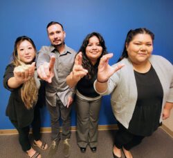 DMC’s ADRC Team finger-spelling A-D-R-C in ASL.