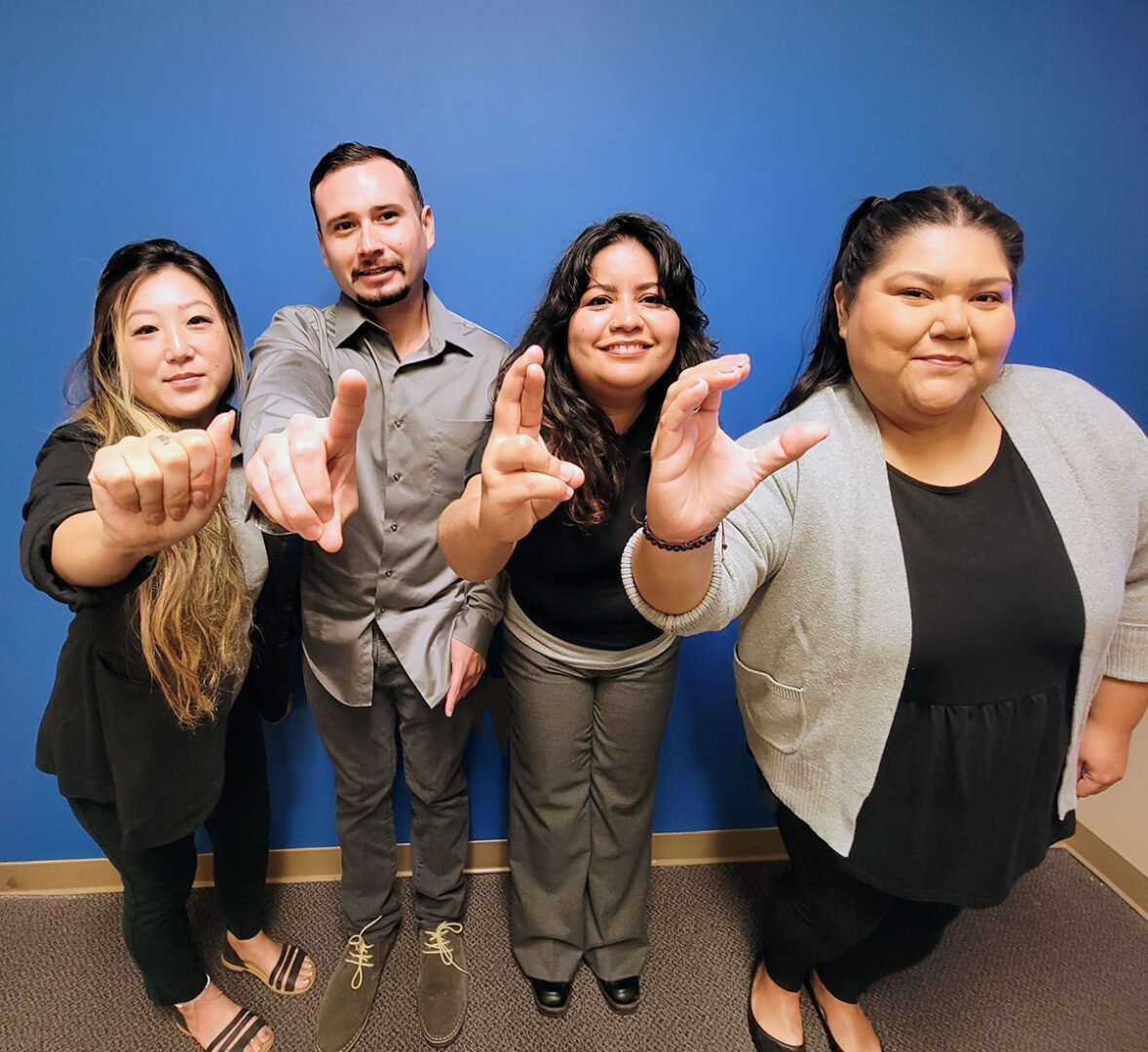 DMC’s ADRC Team finger-spelling A-D-R-C in ASL. 