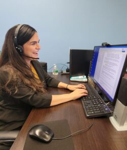 Pictured our AT Coordinator Lizette at desk helping consumer