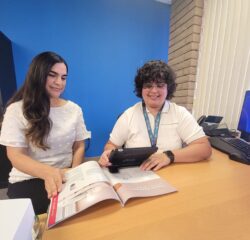 Lizette, Assistive Technology Coordinator (right), and Michelle, Director of Care Services (left), using a magnifier together.