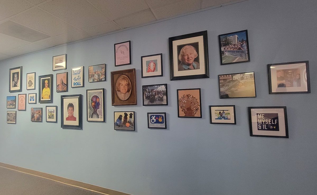 DMC’s own memory wall featuring photos of Dayle McIntosh, Norma Gibbs, Richard Devylder, and benchmark moments for the forty-seven year-old organization.