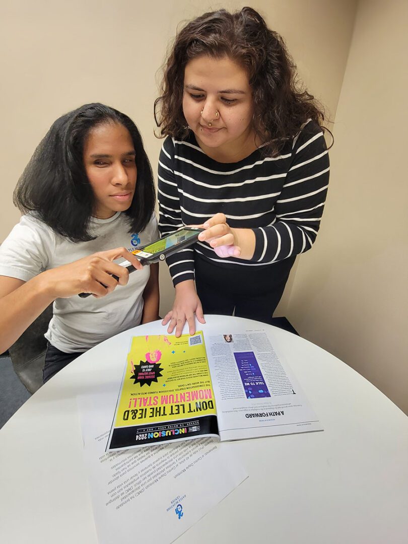 Pictured DMC’s BLVS Team Wendy helping Danyelle use a magnifier