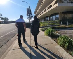 Ivan and Danyelle walking on the sidewalk towards DMC, photo taken from behind them.