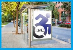 DMC blue logo on white as a bus stop sign on a city street lined with trees and cars.
