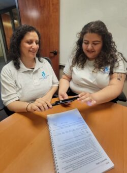 DMC’s ILS Instructors for the Blind Christabel Andrarade using recorder in demonstration to Gabriela Alvarez.