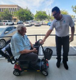Pictured above: Ivan presenting scooter to Tony on ramp at DMC showing him how to use it.