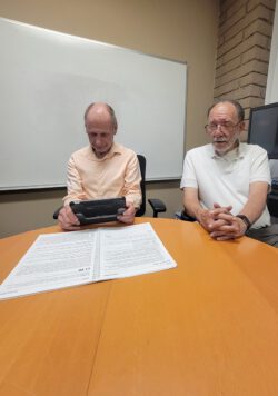 Pictured two older adult consumers using AT Device Magnifier