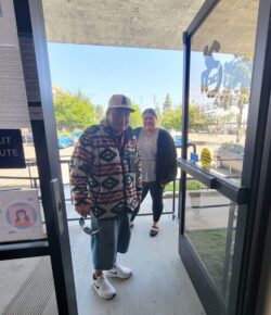 DMC’s Community Living Advocate Esme greeting community member at DMC’s door.