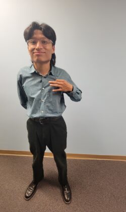 ASL Volunteer Johnan standing inside DMC