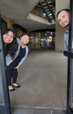 ADRC Team peeking behind open door leading to DMC