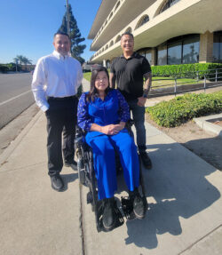 L-R: DMC’s Operations and IT Administrator, Miguel Escargaza, DMC’s Financial Administrator, Christine Nguyen; DMC’s HR Generalist, Michael Susi outside on sunny day next to DMC building