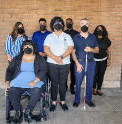 DMC Directors and Leads Masked in front of brick wall practicing COVID protocol